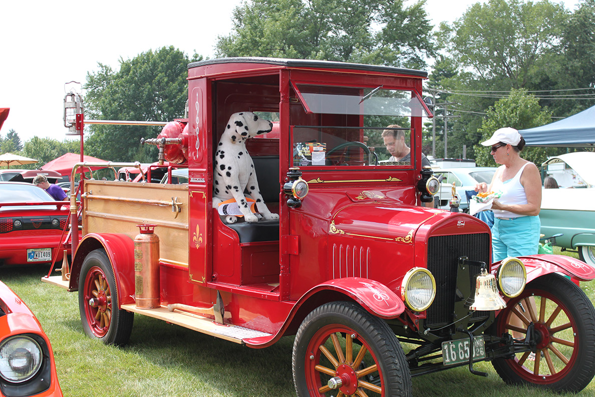 Old red fire truck at a car show.