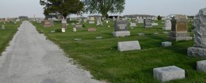 The road leading into Rossville Cemetery with headstones to the right.